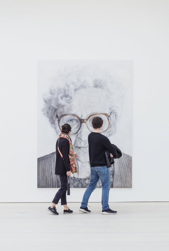  two people looking at canvas painting